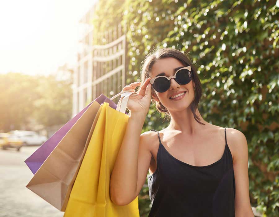 Young woman with shopping bags in a beautiful dress